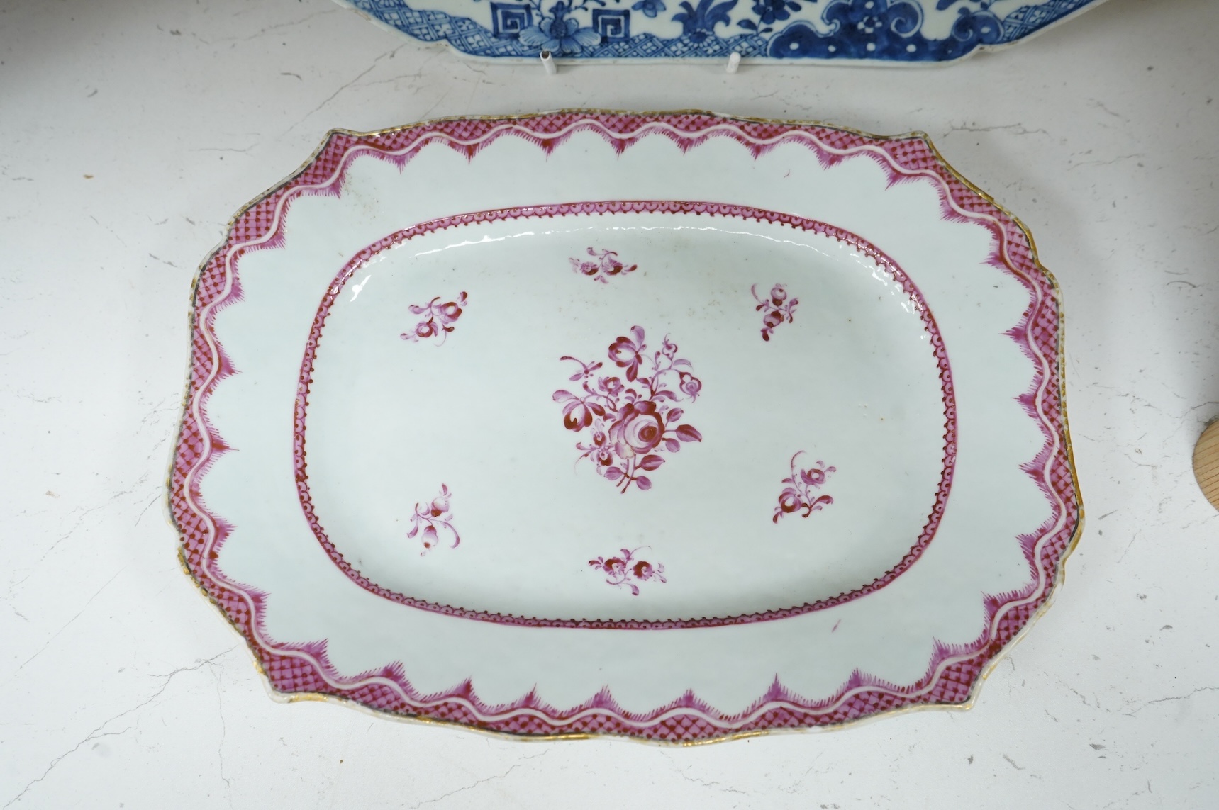 A late 18th century Chinese export blue and white serving dish and a similar famille rose serving platter, largest 37.5cm